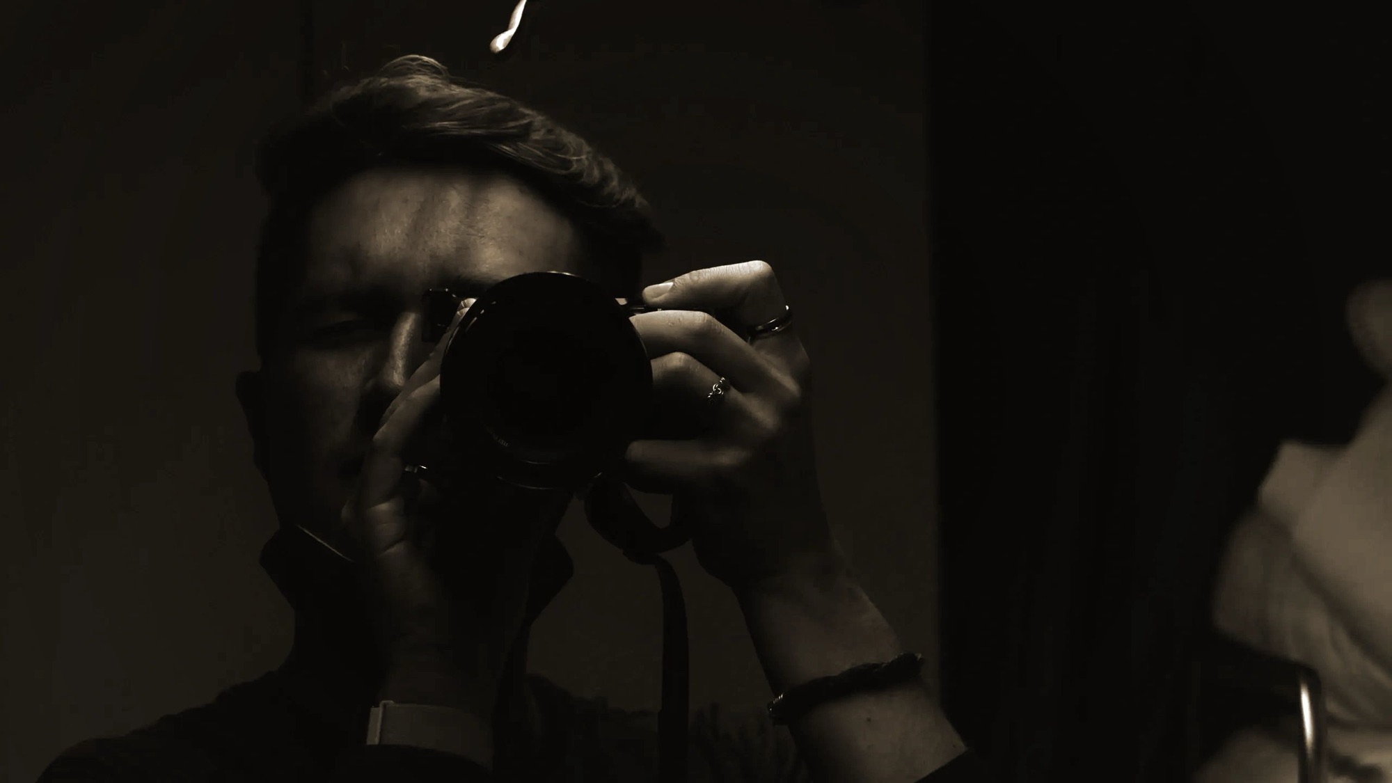 Self-portrait of the photographer, camera in hand