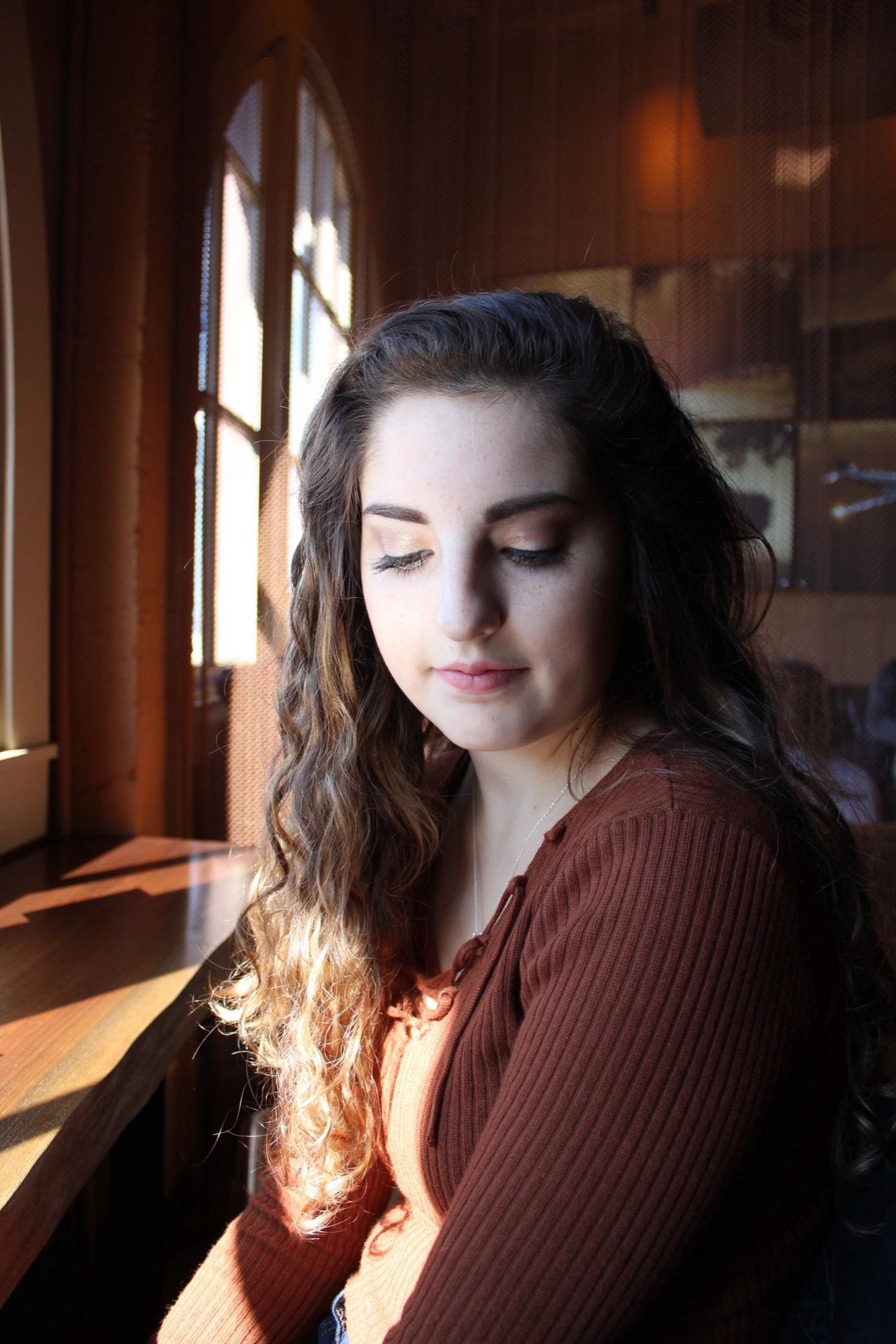 Window-lit portrait of a young woman